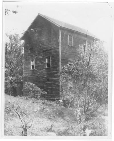 Tall wooden structure built on a steep slope.